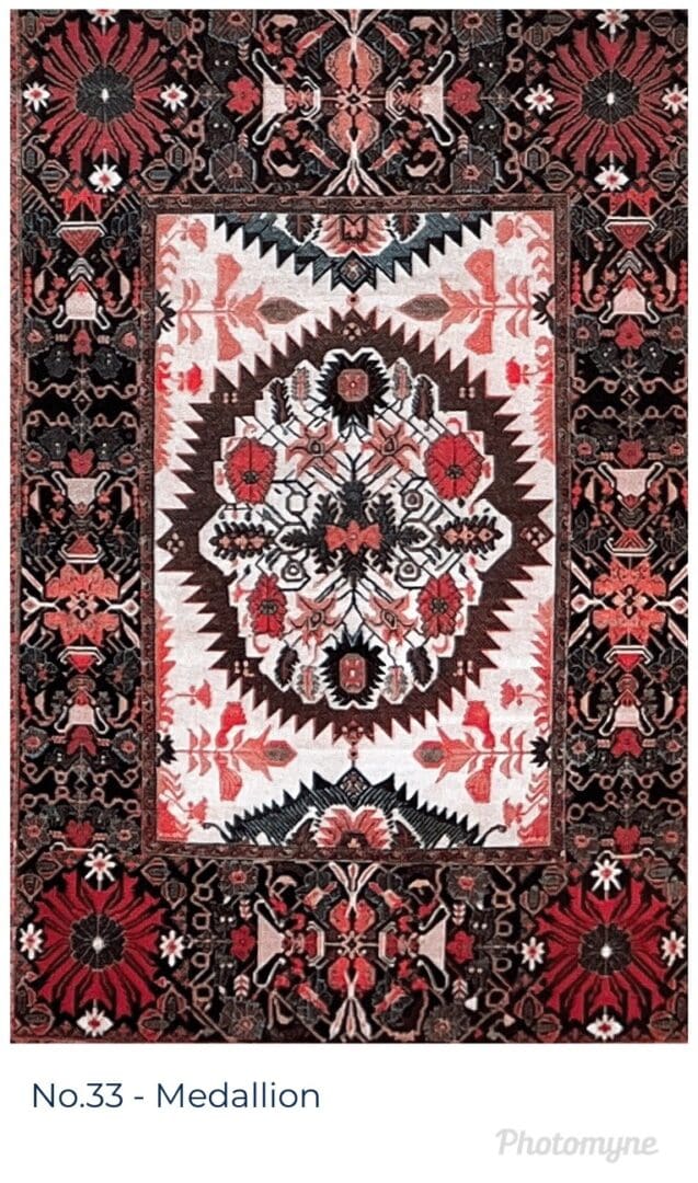 A rug with red, black and white designs on it.