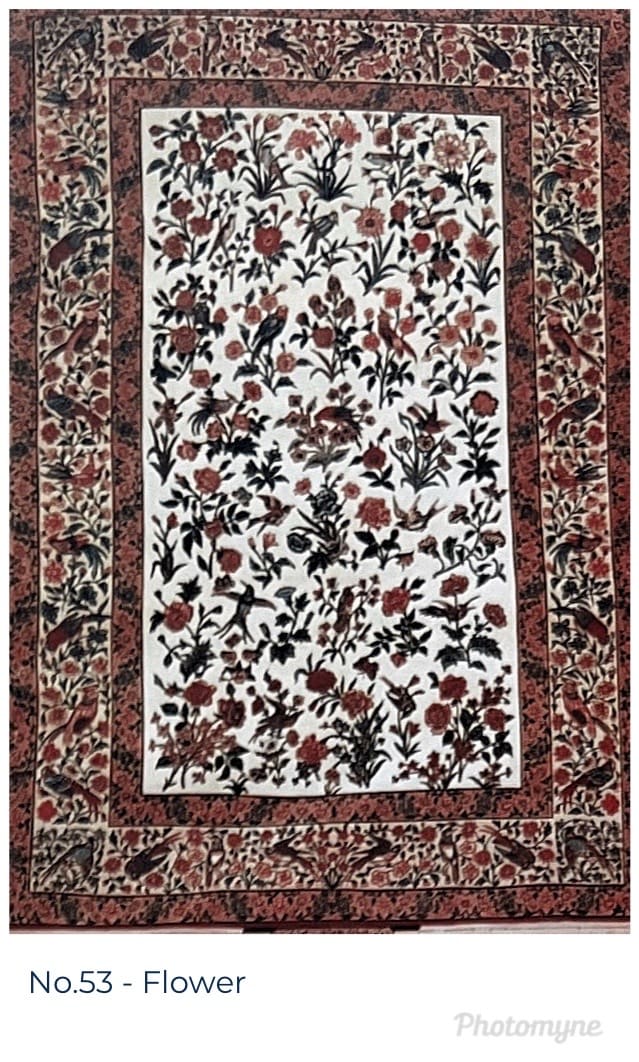 A white and red floral rug with black border