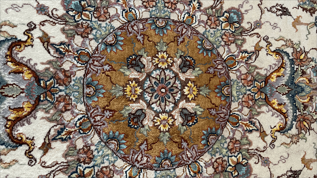 A circular rug with flowers and leaves on it.